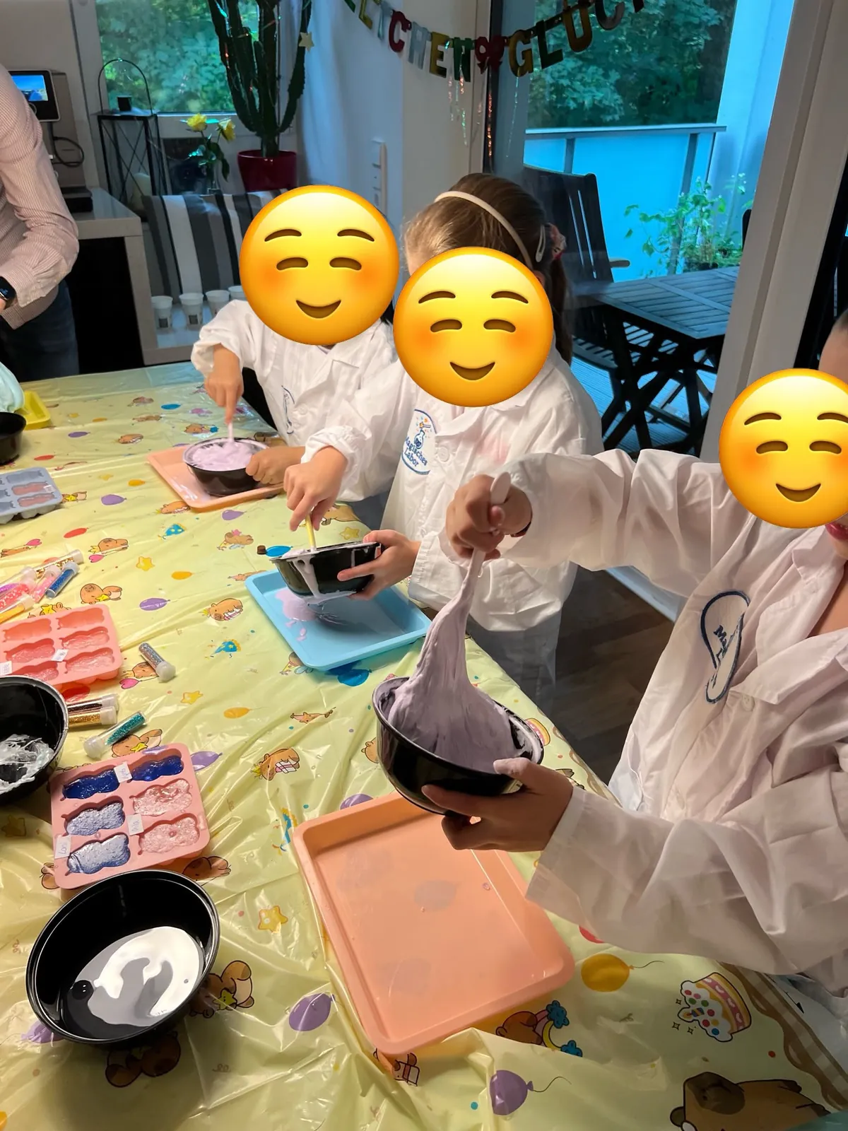 Kindergeburtstag zu Hause: Kinder in Laborkitteln experimentieren mit Farben und Formen